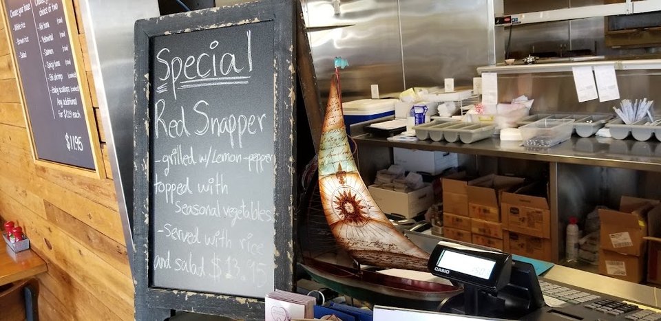 Seafood menu featuring coconut shrimp and clam chowder.